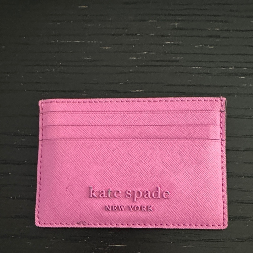 Kate spade bright pink metal logo card holder. 6-pocket; 1 center slot pocket.